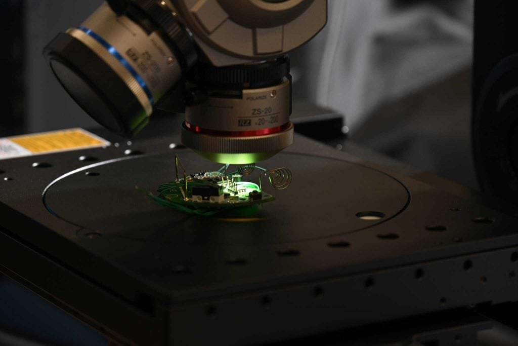 inspecting computer circuitry under a microscope